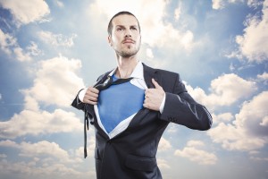 Young businessman acting like a super hero and tearing his shirt